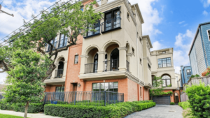 Stunning Mediterranean-style townhome nestled in Montrose, Houston, showcasing architectural beauty, lush landscaping, and a perfect blend of timeless elegance and modern luxury.