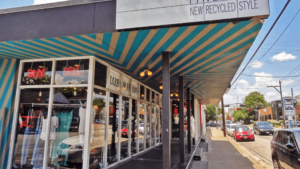 This image shows the exterior of Pavement, a modern and recycled clothing store in the Montrose neighborhood of Houston. Pavement is a popular destination for shoppers looking for unique and stylish clothing at an affordable price. The store offers a wide variety of men's and women's clothing, as well as accessories and home goods. Pavement is committed to sustainability and environmental responsibility, and all of the clothing in the store is either recycled or made from sustainable materials.